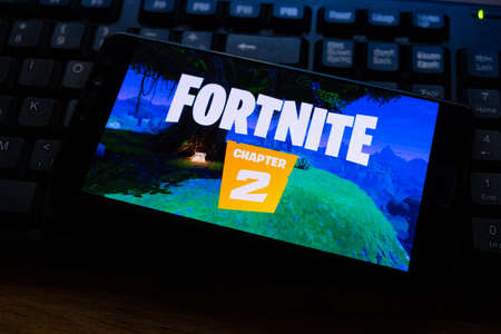 Kostanay, Kazakhstan, October 15, 2019.Mobile phone on the background of the keyboard, with the logo of the popular game fortnite 2, from Epic Games.のeditorial素材
