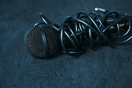 Black microphone dropped to the black wooden floor.Musical instrument for singing and karaoke.の写真素材