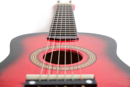 Red six-string guitar on a white background.の写真素材