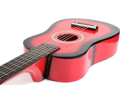 Red six-string guitar on a white background.の写真素材