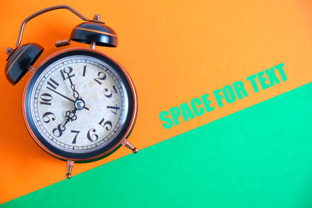 Vintage vintage alarm clock on a background of pastel retro colors.Under an inclination