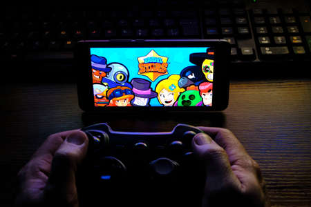 Kostanay, Kazakhstan, February 12, 2020.Joystick and mobile phone with the logo of the popular game Brawl Stars, from Supercellのeditorial素材