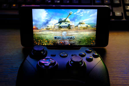 Kostanay, Kazakhstan, February 12, 2020.Joystick and mobile phone with the logo of the popular game World of Tanks, from Wargaming.のeditorial素材
