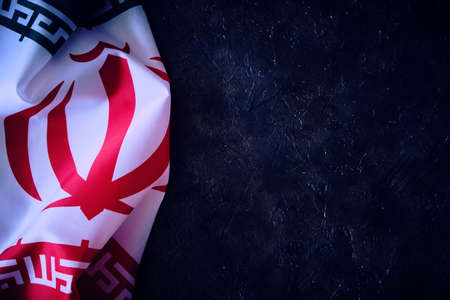 National flag of Iran on a dark background with space for textの写真素材