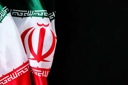 National flag of Iran on a dark background with space for textの写真素材