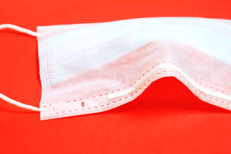 Used a medical face mask on a red background