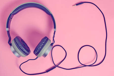 Wired headphones in khaki on a pink background.Vintage and retroの写真素材
