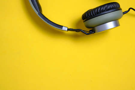 Wired headphones in khaki on a yellow backgroundの写真素材