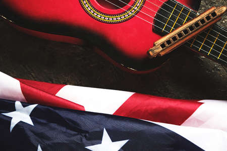 Star spangled banner, guitar and harmonica. Musical instrument and flag of the United States of Americaの写真素材
