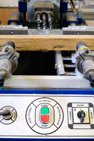 Industrial machine with control panel buttons and switches