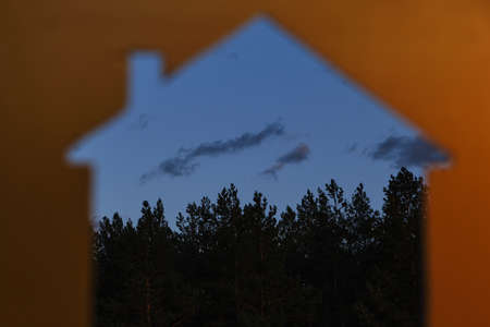 Silhouette of a house against the evening sky and forest.Travel and outdoor recreation, In the open,