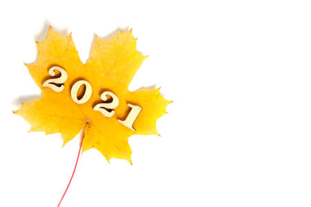 Yellow maple leaf with numbers two thousand and twenty-one year,on a white background.の写真素材
