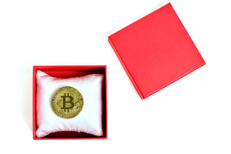 Bitcoin coin in a red gift box on a white background.Mining gift for Valentine's Dayの写真素材