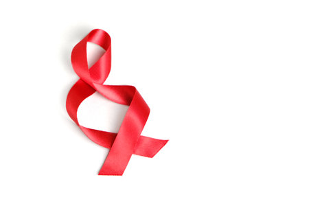 Red ribbon twisted in a spiral on a white background