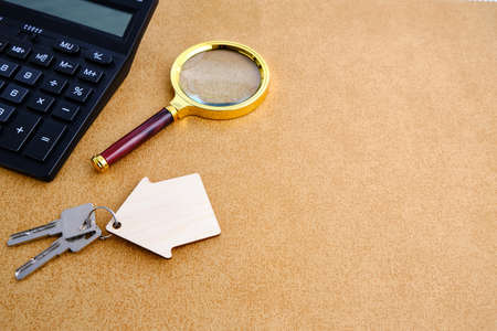 Calculator, magnifier and house keys.Concept of buying and selling housing, mortgages and renting a...