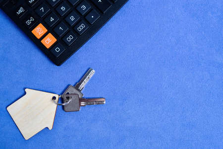 Calculator, and house keys.Concept of buying and selling housing, mortgages and renting a house or...