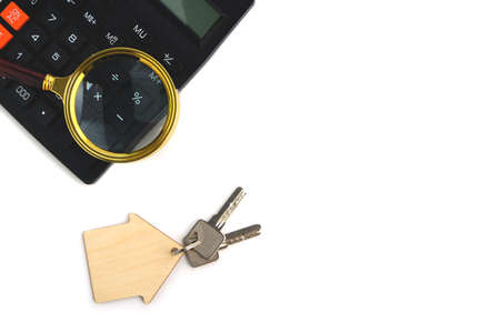Calculator, magnifier and house keys.Concept of buying and selling housing, mortgages and renting a...