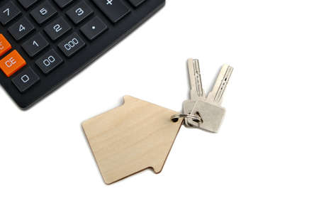 Calculator and house keys.Concept of buying and selling housing, mortgages and renting a house or apartmentの写真素材