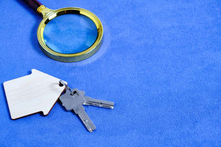Magnifying Glass and Keys House or Apartment Concept of Buying and Selling Housing, Mortgages and Renting a House or Apartment.の写真素材