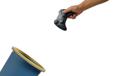 Gaming joystick is thrown into trash.Concept of refusal for computer games