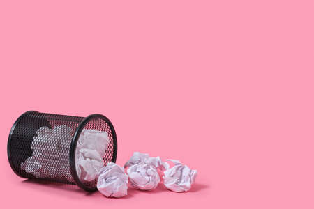 Rashes of crumpled paper from trash can, on pink backgroundの写真素材