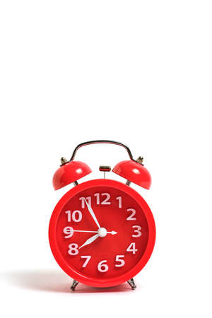 Red alarm clock isolated on white background shows 7 hours 55 minutes morning, wake up for school or workの写真素材