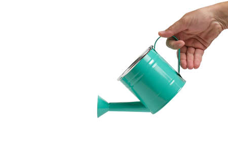Green watering can in hand on a white background, isolateの写真素材
