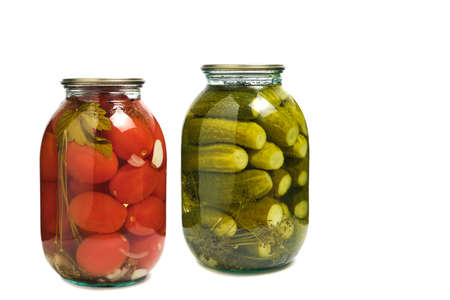 Jars of pickled cucumbers and tomatoes on white background, isolate. Preparations for winter