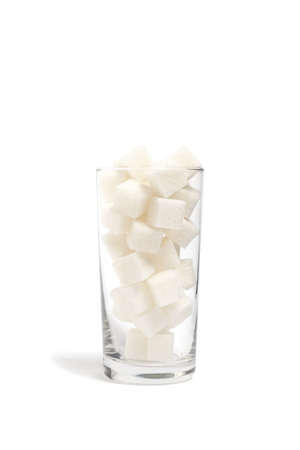 Refined sugar cubes in a clear glass glass