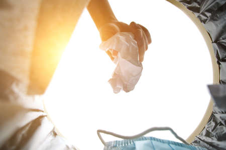 Man throws crumpled piece of paper into trash.View from bucketの写真素材