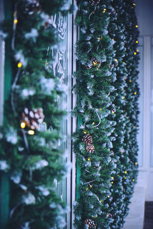 Christmas decoration with pine twigs and garlands store facadeの写真素材