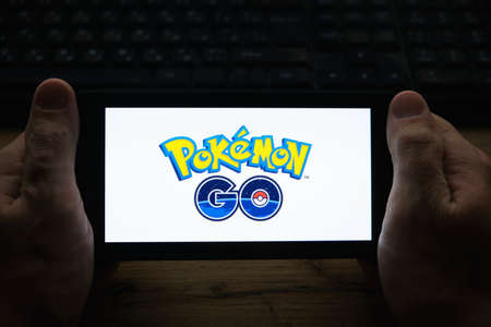 Kostanay, Kazakhstan, November 01, 2021. In hand is mobile phone with a screensaver of popular game Pokemon GOのeditorial素材