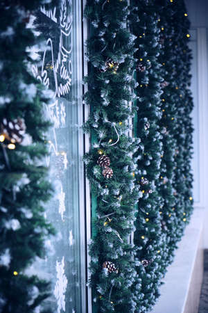 Christmas decoration with pine twigs and garlands store facade