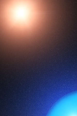 Deep black space, bright yellow light hot sun and blue light icy planetの写真素材
