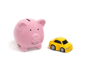 Piggy bank and yellow car on white backgroundの写真素材