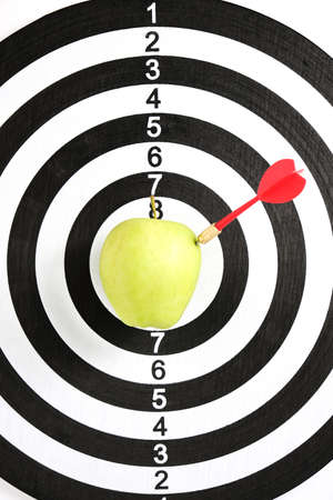 Concept achieving goal. Achieving goals in business and life. Dartboard with darts stuck right bullseyeの写真素材