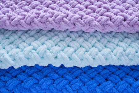 Background, warm, delicate and plush handmade baby blankets in colors of blue, lilac and mintの写真素材