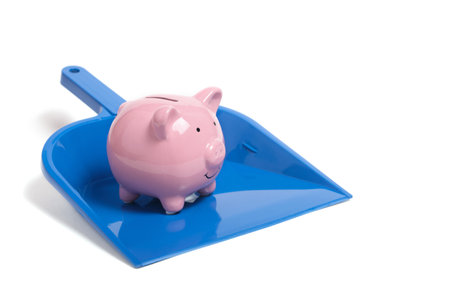Piggy bank in dustpan for garbage collection.Concept lost savings and losses in businessの写真素材