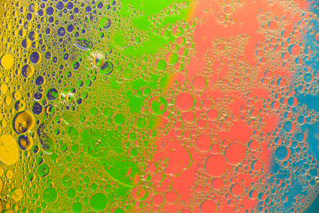 Abstract background oil stains and stains on the surface of water on a bright colored background