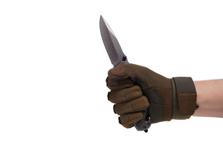 Hand in tactical glove, holding folding knife, on white backgroundの写真素材