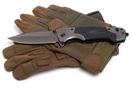 Folding knife and tactical military gloves on white backgroundの写真素材