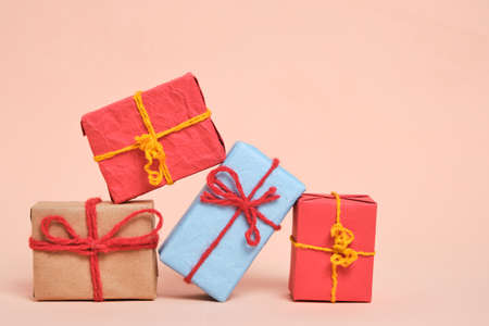 Gifts packed in multicolored paper on pastel beige background.Concept Christmas holidays and eighth March in springの写真素材