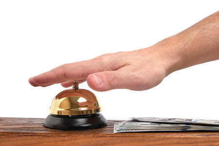 Pressing your hand bell hotel service and dollars table.Concept hotel, travel and paid holidaysの写真素材