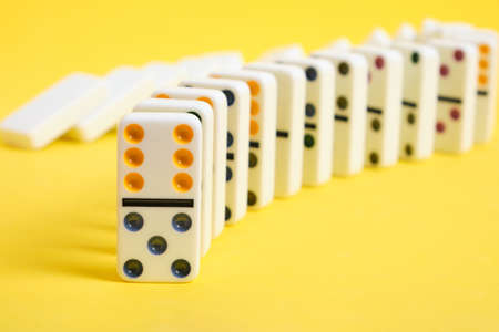 Domino knuckles on a yellow background, domino effectの写真素材