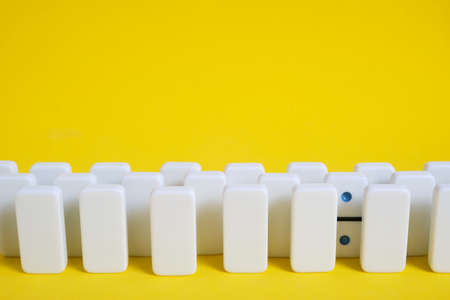 Rows white domino chips with one eye catching, concept is individual and not like everyone elseの写真素材