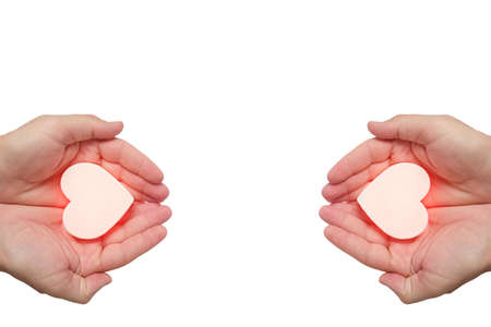 Hot white heart in mans hand on white backgroundの写真素材