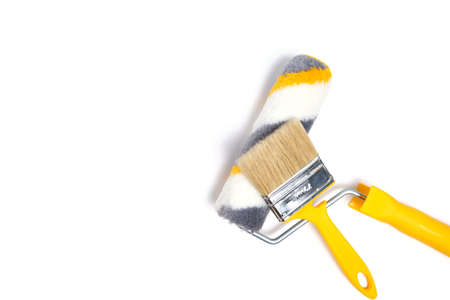 Paint roller and brush for wall painting and repair, on white backgroundの写真素材