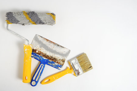 Paint roller, brush and spatula on a white background, repair toolの写真素材