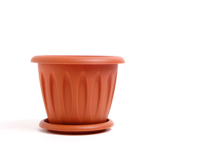 Brown, plastic, empty flower pot on a white backgroundの写真素材
