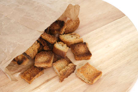 Fried breadcrumbs are poured out paper bag wooden backgroundの写真素材